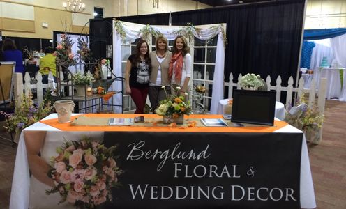 Registration table with floral wedding and decor tarp