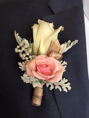 A white and pink rose boutonniere