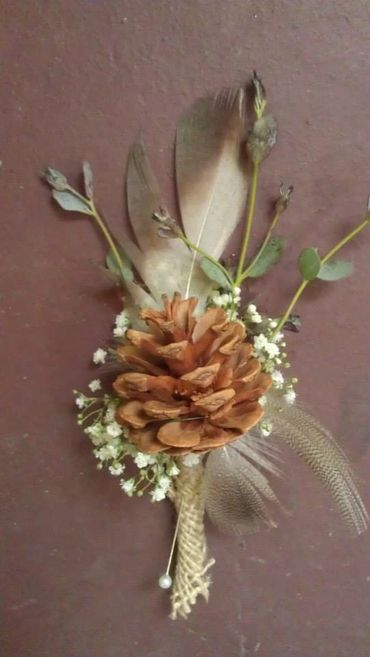 A dance flower with pinecone and feathers