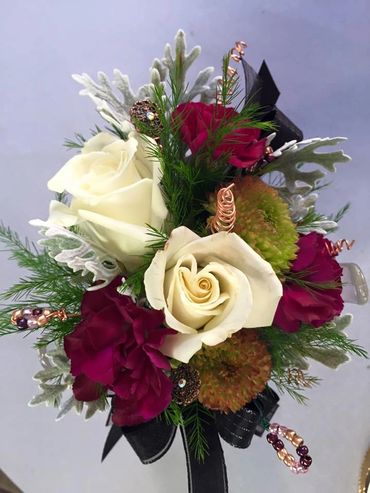 Assorted flowers with a black ribbon