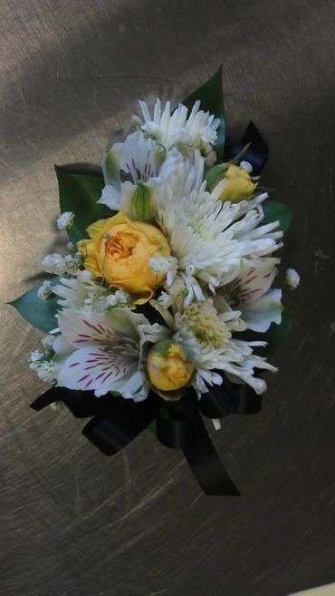 White and yellow flowers with a black ribbon
