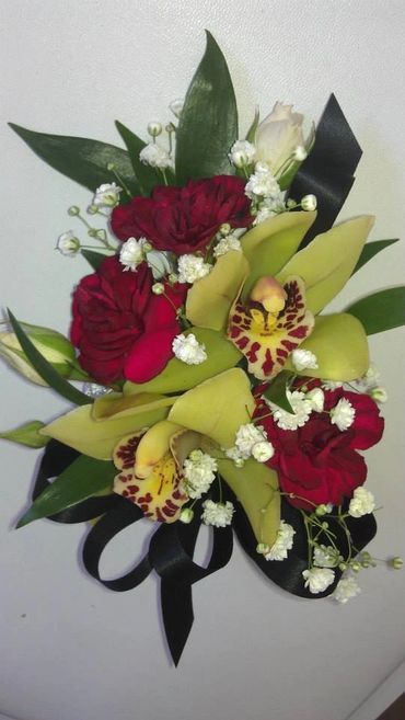 Red and green flowers with a black ribbon