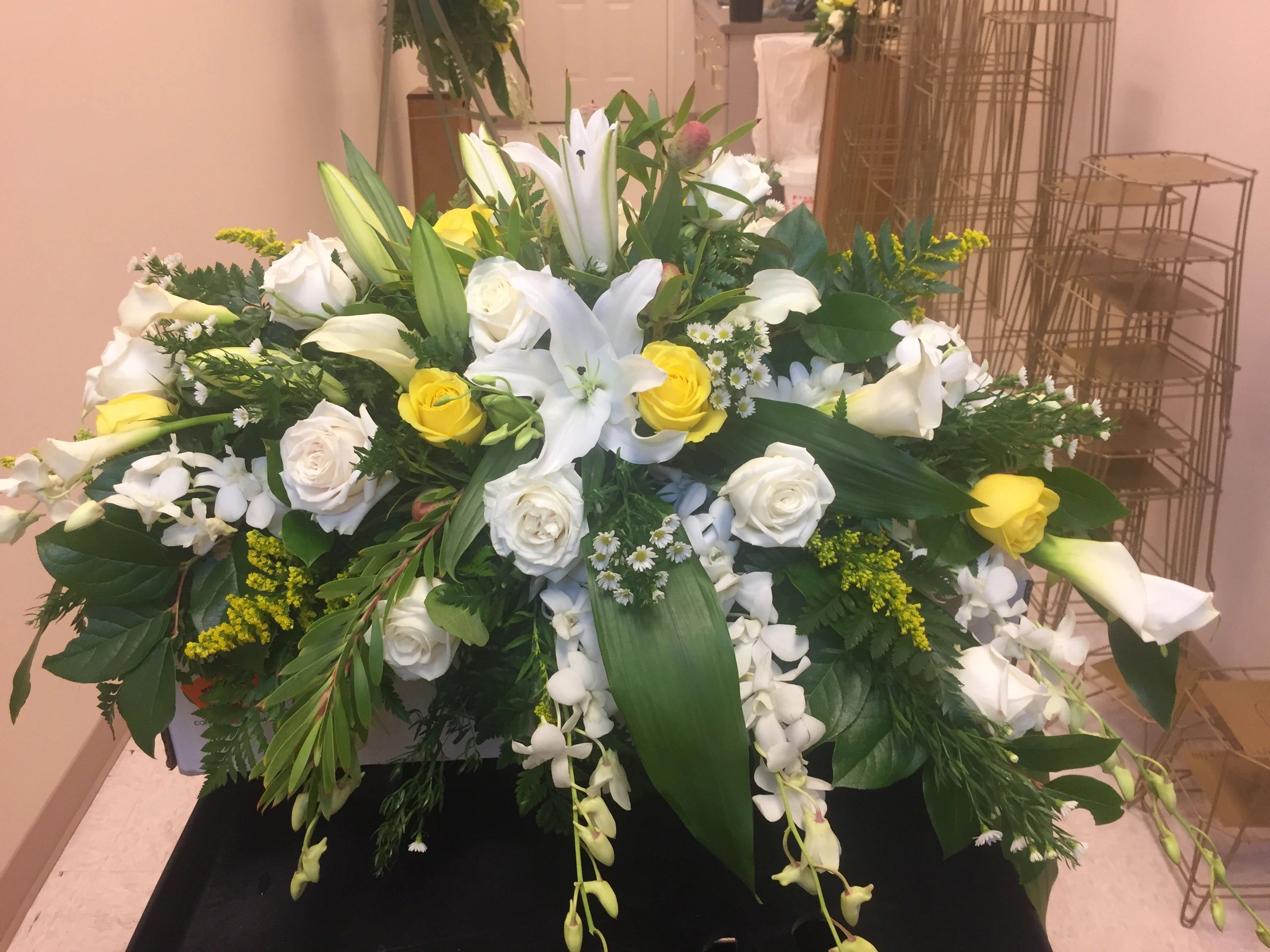 White and yellow roses with greenery