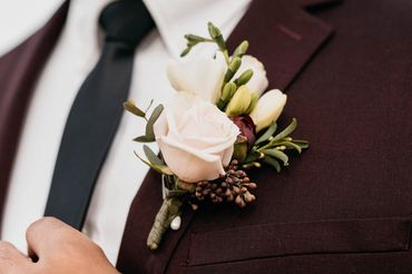 A white and pink floral boutonniere