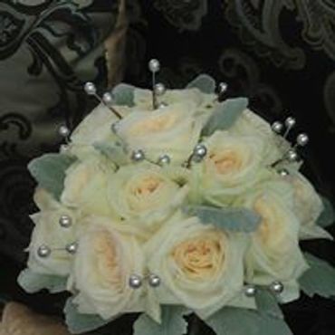 A white rose bouquet and silver pods