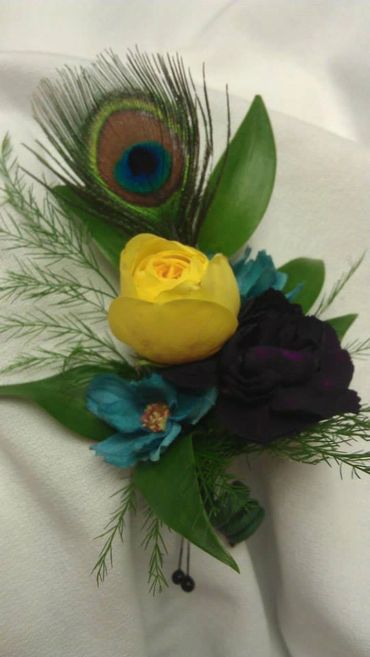 Yellow and blue flowers with a peacock feather