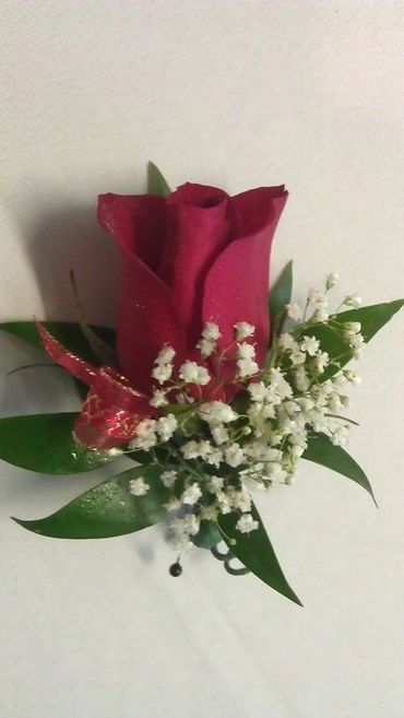 A rose with leaves and a pin