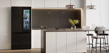 Sleek InstaView fridge blending with a warm living and dining interior.