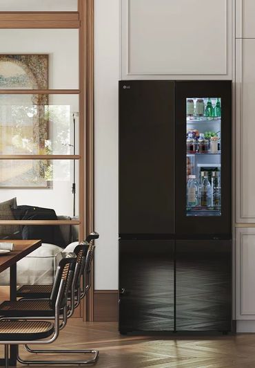 Matte black InstaView fridge styled in a bright, modern kitchen.
