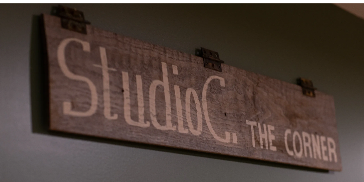 Rustic wooden sign reading 'Studio'