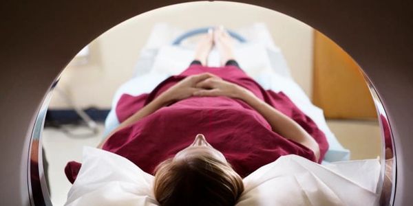 Patient undergoing CAT SCAN in a medical facility.