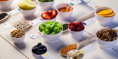 Portion cups of healthy ingredients on wooden table.