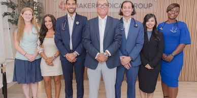 Doctors at Shaker Medical standing next to each other smiling.