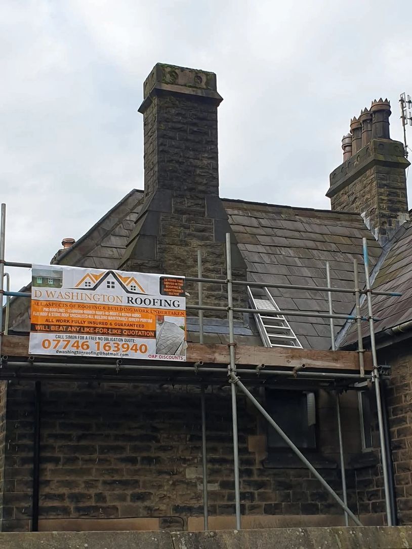 D Washington Roofing. Iamge shows House with scafolding and Roofing Sign banner and slate roof.