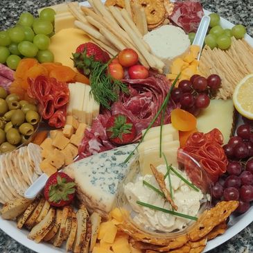 Charcuterie board with meat cheese olives fruit and crackers