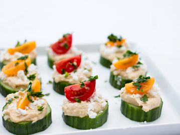 Cucumber bites with cream cheese and tomato