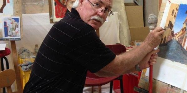 Artist at work on new painting in Italian art studio