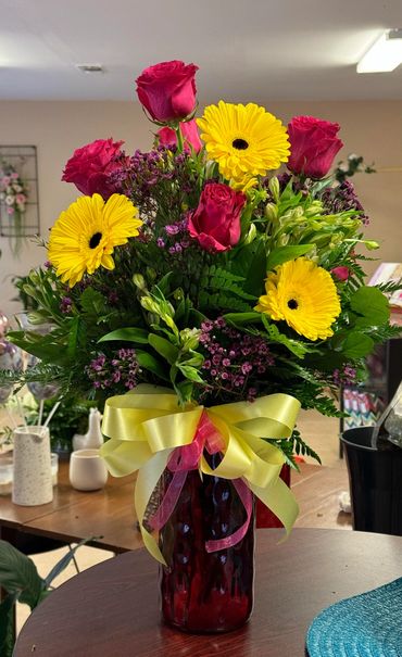 Pink Roses and Yellow Gerbra Daisy's, Wax Flower, assorted Flowers and Greens