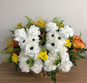 Two Flower Puppies with 1/2 dz Roses Butter Flies and assorted Flowers.