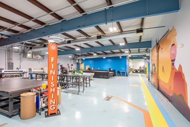 Production and finishing area with colorful wayfinding and bright industrial layout.