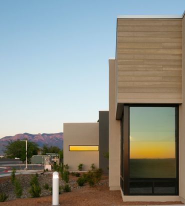 Office building facade with clean lines, large window, and minimalist architectural detailing.