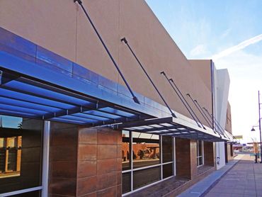 Steel canopy over classroom windows on the exterior of a contemporary school building.