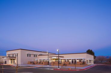 Legacy Home Health exterior at dusk with warm lighting and contemporary stucco architecture.