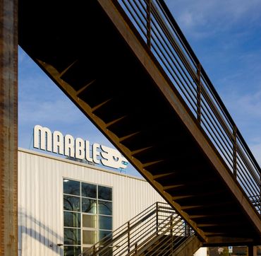 Marble Brewing exterior with elevated steel walkway and modern industrial design in Albuquerque.