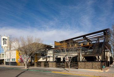Exterior of Marble Brewing featuring steel framework, rooftop deck, and brewery silos.
