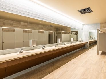 Modern restroom at Quezada’s Comedy Club with warm lighting and clean contemporary design.