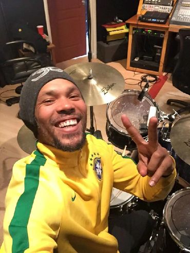 Marcio Santos playing drums in the recording studio.