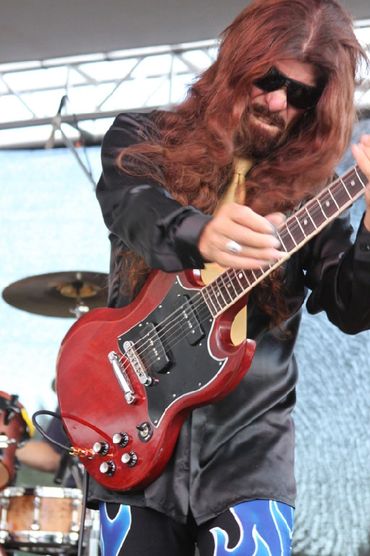 Randolph Sanchez of RXR playing guitar at the 4&20 Blackbird Festival in Weed, Ca.