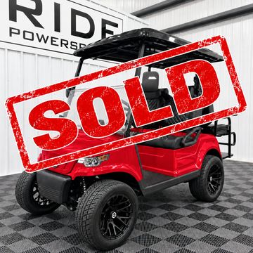 Red golf cart with a sold stamp.