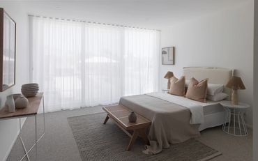 Minimalist bedroom with neutral tones and natural textures.