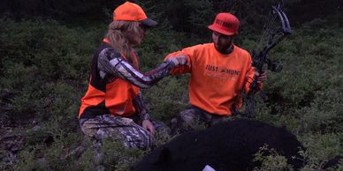 A mom congratulating her son after hunting a black bear.