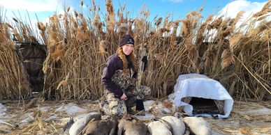 A girl with geese while hunting.