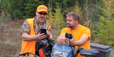 Two hunters checking out GPS coordinates while moose hunting.