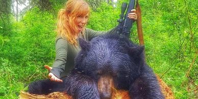 Amanda Lynn Mayhew with a very big bear in Alberta while bear hunting.