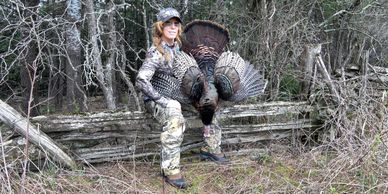 A girl with a turkey after turkey hunting.