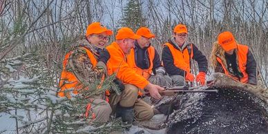 A moose gang with a moose down.