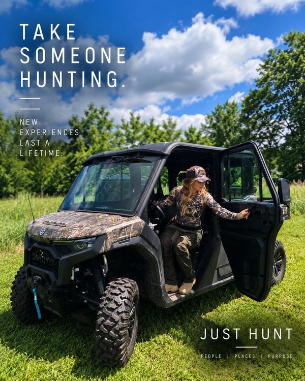 Woman in camo gear stepping out of an off-road vehicle in grassy area.