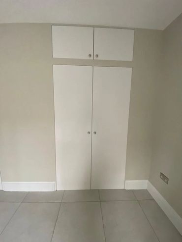 Completed bespoke outbuilding fitted storage.