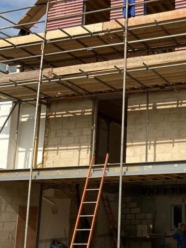 Rear view of house under construction. Loft conversion, extension and full renovation in progress.