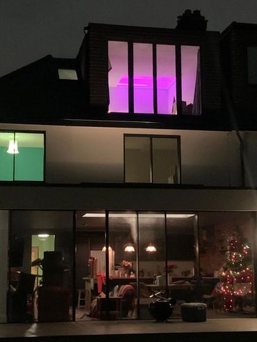 Rear view of completed rear extension, home renovation and loft conversion at night