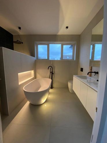 New bathroom with feature bath and inset storage with LED lighting