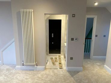 Hallway in loft conversion leading to new bathroom and staircase