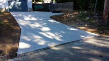 Newly poured concrete driveway with clean edges.