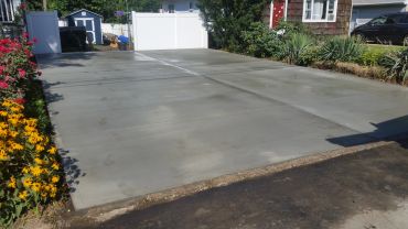 New concrete driveway with garden sides.