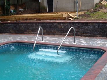 Sunken pool steps with handrails.