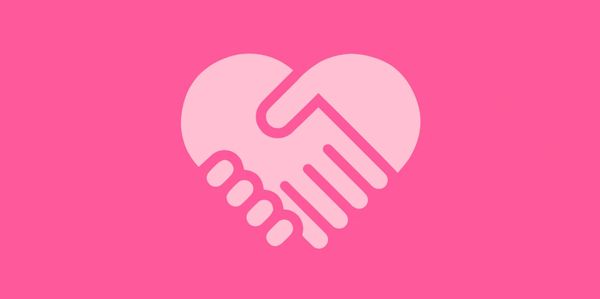 Handshake forming a heart shape on a pink background.
